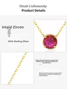 Detail of 14K gold plated S925 silver necklace with round red zircon inlay