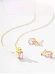 Detail of luxury S925 silver jewelry set with square pink zircon and golden finish