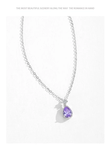 Macro shot of a pear-cut purple crystal teardrop pendant on a silver S925 necklace