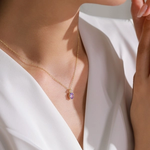Elegant 14K gold S925 silver necklace with oval purple amethyst pendant on a female model