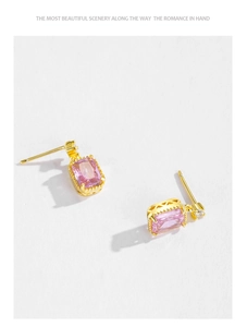 Macro detail of gold plated S925 silver stud earrings with rectangle pink zircon