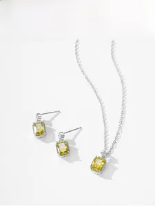 Close-up of S925 silver jewelry set with rectangular yellow zircon pendant and earrings
