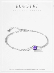 Close-up of S925 sterling silver bracelet featuring a round purple zircon in 4-prong setting