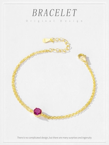 Detail of S925 sterling silver gold bracelet with red zircon and adjustable extension chain