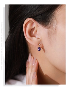 Détail d'une boucle d'oreille vintage en argent S925 avec améthyste sur modèle
