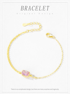 Detail of S925 silver gold bracelet with pink zircon and lobster clasp closure