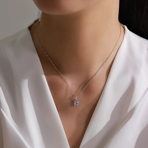 Elegant S925 silver necklace with purple teardrop crystal pendant worn by model