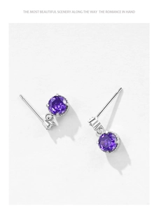 Macro shot of S925 sterling silver earrings with purple zircon in a multi-claw setting