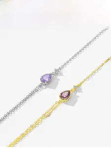 Detailed shot of pear-shaped purple and pink zircon bracelets in gold and silver plating