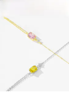 Detail of S925 silver bracelets with pink and yellow square zircons in gold and silver finish