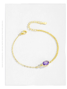 Detail of S925 silver gold bracelet with oval purple zircon and lobster clasp