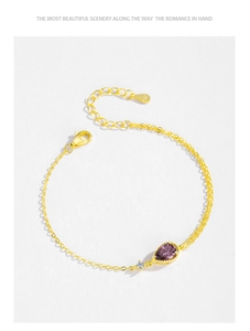Macro detail of S925 sterling silver stamp on gold plated bracelet with pear cut zircon