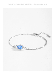 Detailed macro shot of S925 sterling silver bracelet with oval blue zircon and O-chain