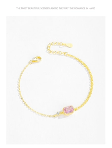 Macro detail of S925 sterling silver stamp on golden bracelet with pink zircon stone