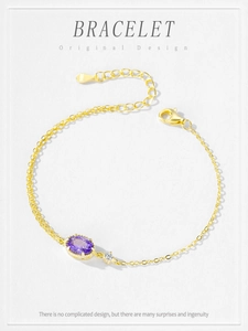Detail of S925 sterling silver gold bracelet with oval purple crystal and lobster clasp