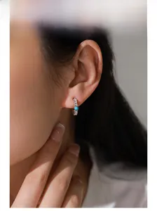 Detail view of S925 sterling silver hoop earring with woven texture and turquoise stone