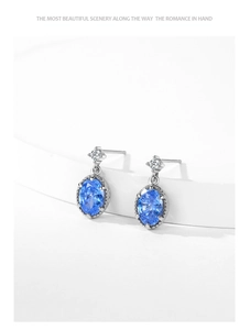 Vue macro de boucles d'oreilles en argent 925 avec zircon bleu ovale et petit diamant