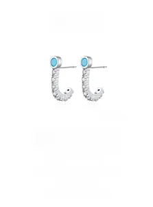 Macro shot of S925 sterling silver J-shaped stud earrings with turquoise and micro zircons