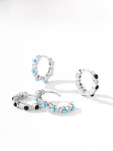 Detail of S925 silver hoop earrings with turquoise, black beads and white zircon accents