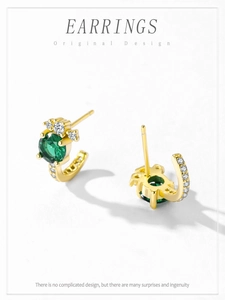 Macro view of gold-plated S925 silver earrings with green zircon and white cubic zirconia