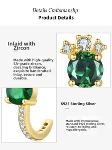 Macro detail of S925 sterling silver emerald zircon stud earring with gold finish