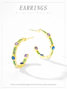 Macro shot of gold-plated S925 silver C-shape earrings with colorful zircon stones