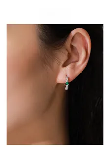 Gros plan d'un mannequin portant des créoles bambou en argent 925 et pierre de malachite verte