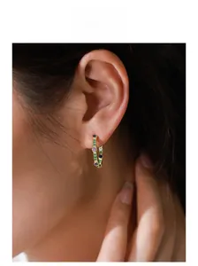 Close-up of S925 silver 18K gold plated hoop earring with colorful inset zircons on model