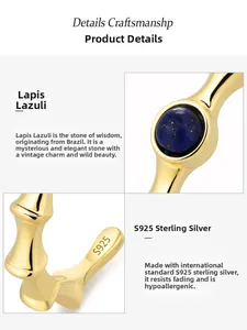 Macro detail of S925 sterling silver stamp and round lapis lazuli on golden bamboo ring