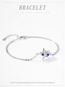 Detail of S925 sterling silver star bracelet with blue zircons and engraved hallmark