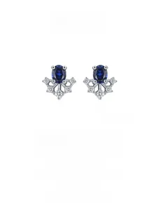Detail of vintage S925 silver earrings featuring oval blue gems and sparkling diamonds