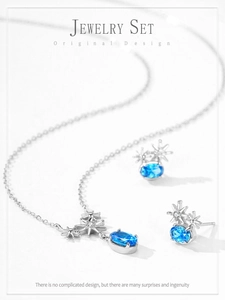 Close-up of 925 sterling silver jewelry set featuring blue oval gems and star motifs
