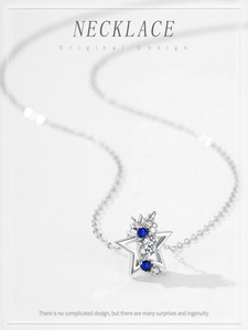 Macro shot of S925 silver star pendant with blue cubic zirconia and white diamonds