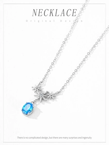Macro detail of 925 silver star pendant with deep sea blue zircon and fine chain