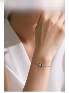 Detail of 925 sterling silver double-layer bracelet with star pendants on female wrist