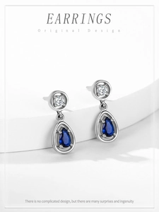 Macro shot of S925 sterling silver drop earrings featuring deep blue sapphire gemstones