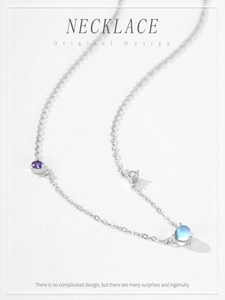 Macro shot of S925 silver necklace featuring three colorful moonstones on a fine chain