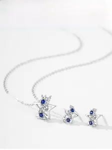 Detailed view of S925 silver star pendant necklace and earrings set with blue crystals