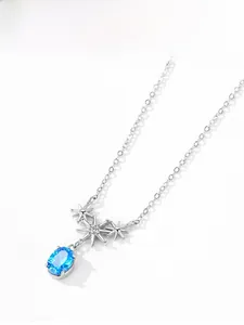 Detailed close-up of 925 silver necklace with star pendants and sea blue crystal stone