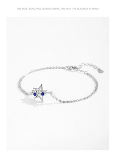 Detailed view of S925 sterling silver star bracelet with blue and white cubic zirconia