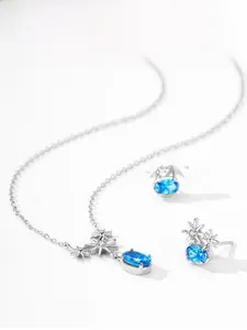Detailed set of 925 silver star pendant necklace and earrings with blue zircon