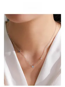Close-up of S925 sterling silver necklace with blue moonstone on a female model