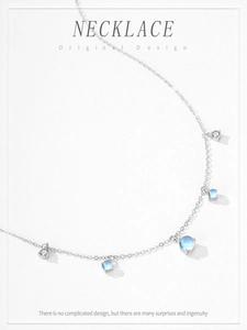 Detail of S925 silver necklace featuring round moonstone and zircon pendant droplets