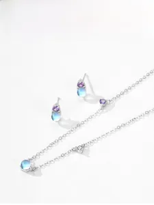 Close-up of S925 silver necklace and earrings with blue moonstones and purple gems