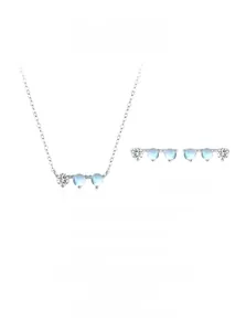 Macro detail of S925 silver moonstone necklace and earrings set with refined minimalist design