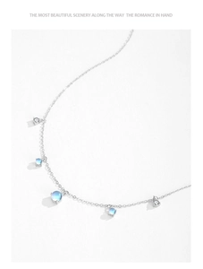 Macro detail of S925 silver necklace featuring round moonstones and zircon accents