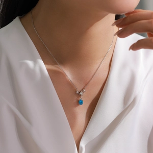 925 silver necklace with blue zircon star pendant worn on female model collarbone