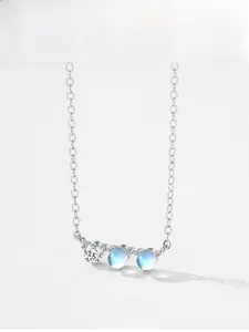 Macro detail of S925 sterling silver necklace featuring moonstones and zircon gems