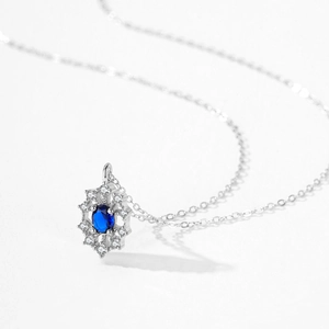 925 silver necklace featuring a sapphire pendant with diamond-encrusted floral design