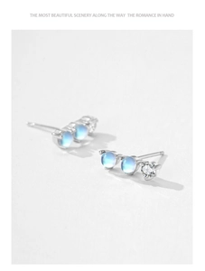 Detailed close-up of S925 sterling silver earrings with blue moonstones and clear zircons